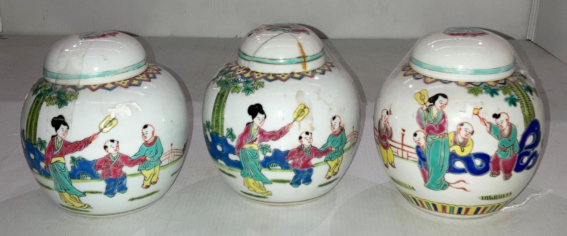 Set of three vintage Famille Rose hand-painted ginger jars (one with repaired lid), 12.