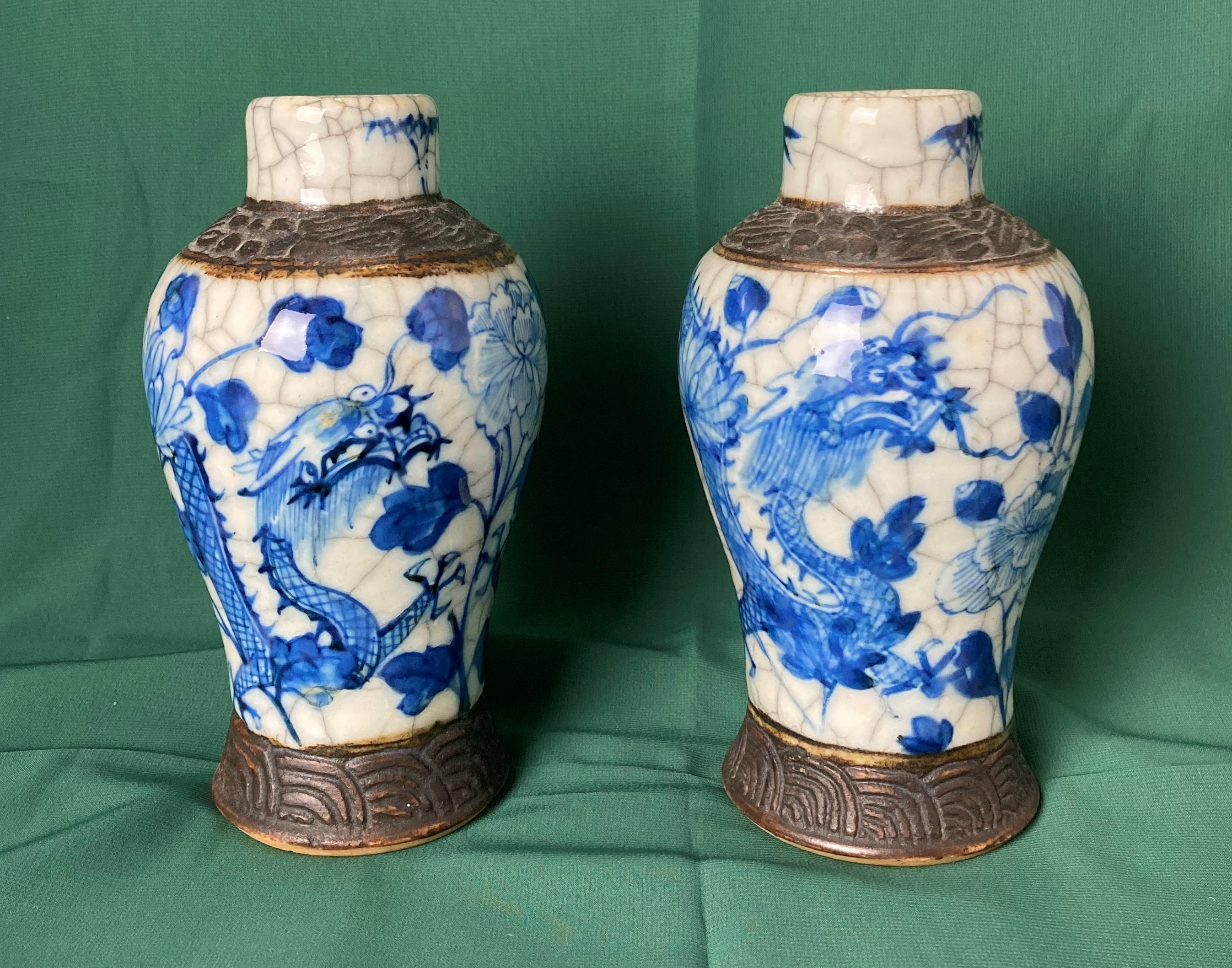 Pair of blue and white Nanking vases decorated with dragons and flowers with stamp to underside,
