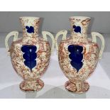 Pair of hand-painted two-handled urn vases with floral design,