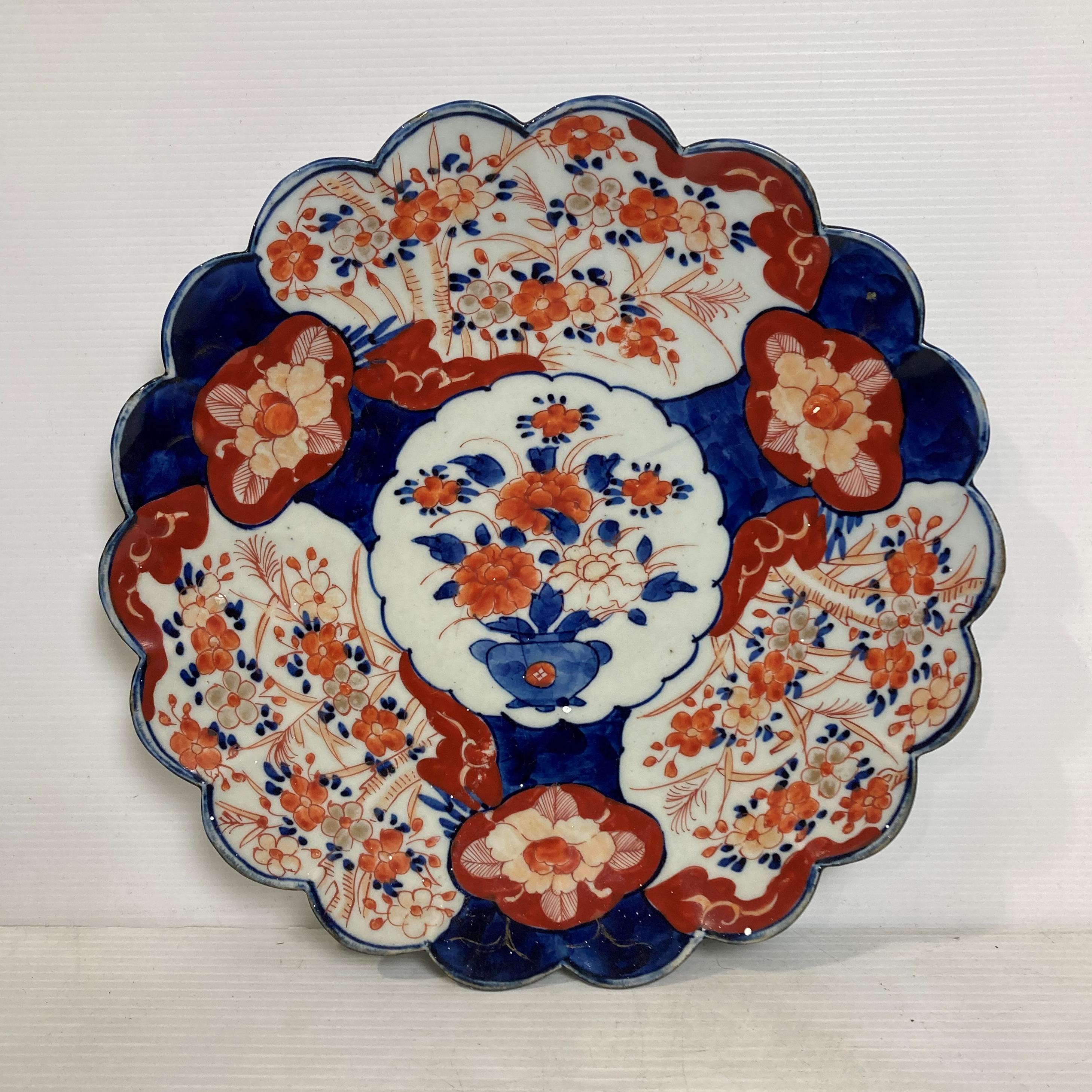 An Oriental hand-painted Imari pattern scalloped plate, 30.