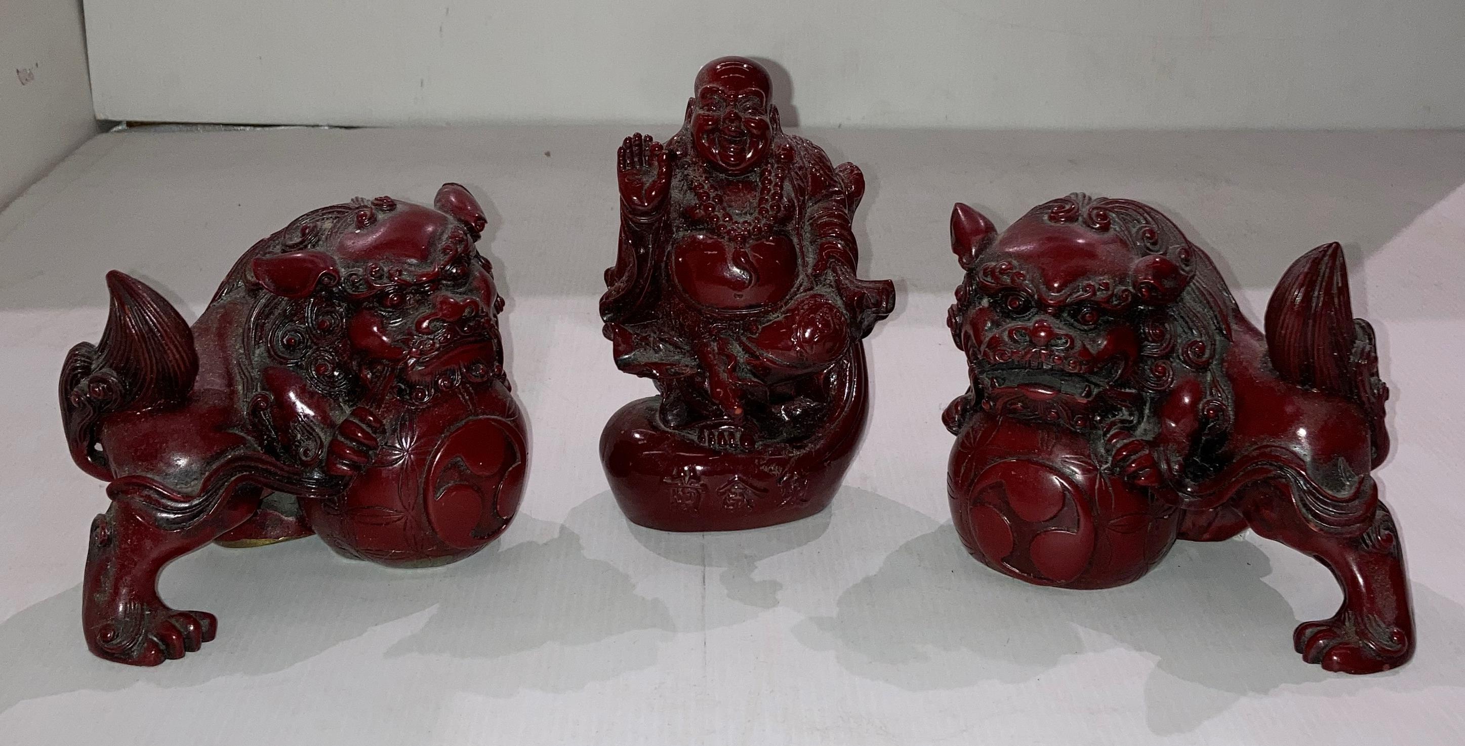 A pair of Mid Century Chinese red resin Foo dog figurines (14cm x 11cm high) and a red resin
