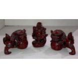 A pair of Mid Century Chinese red resin Foo dog figurines (14cm x 11cm high) and a red resin