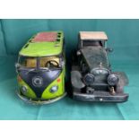 Two metal display vehicles including a VW Campervan,