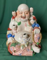 A vintage Oriental porcelain Laughing Buddha with five climbing children - possibly Early 20th