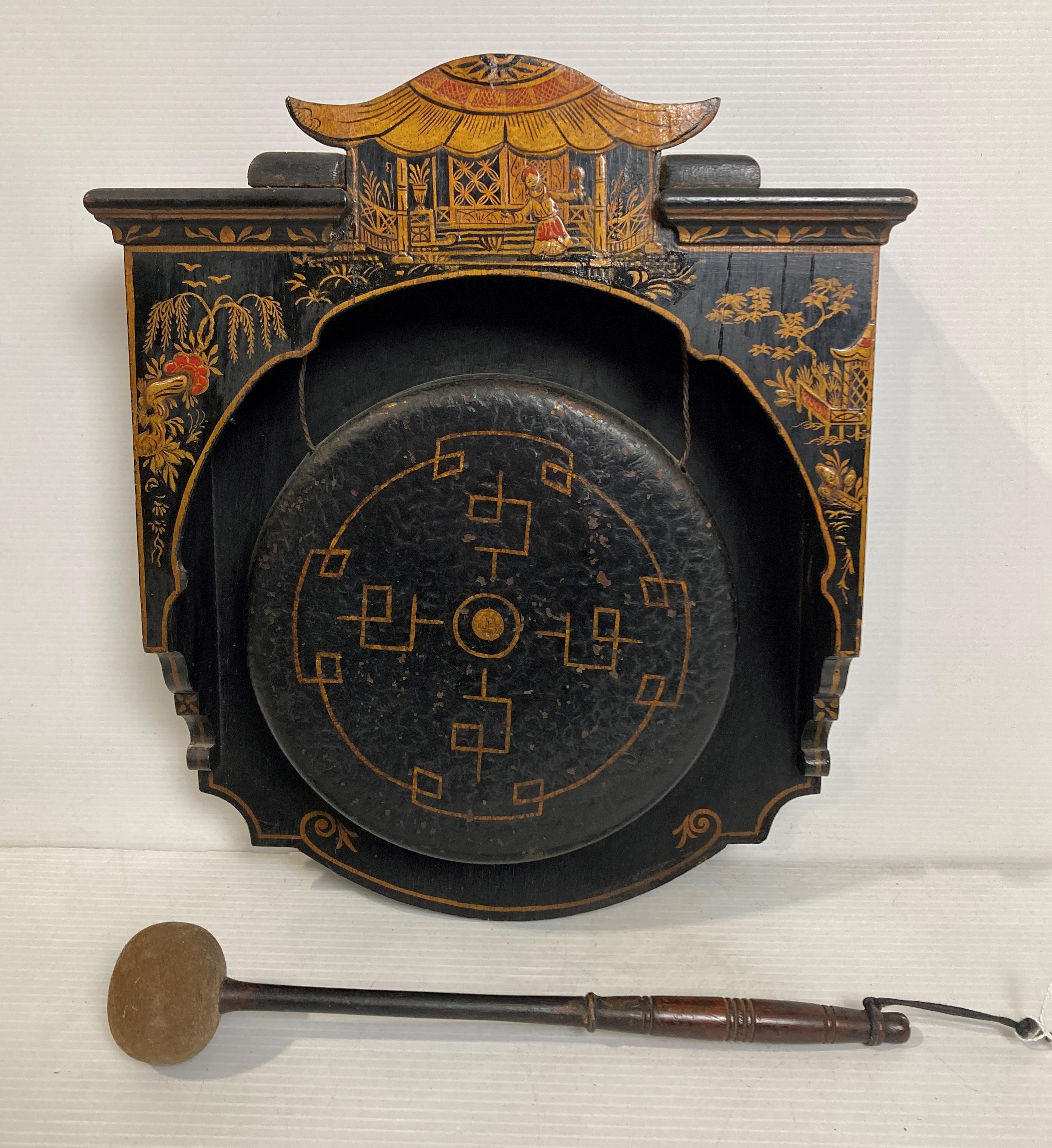 Oriental ebony dinner gong with gold and red detailing,