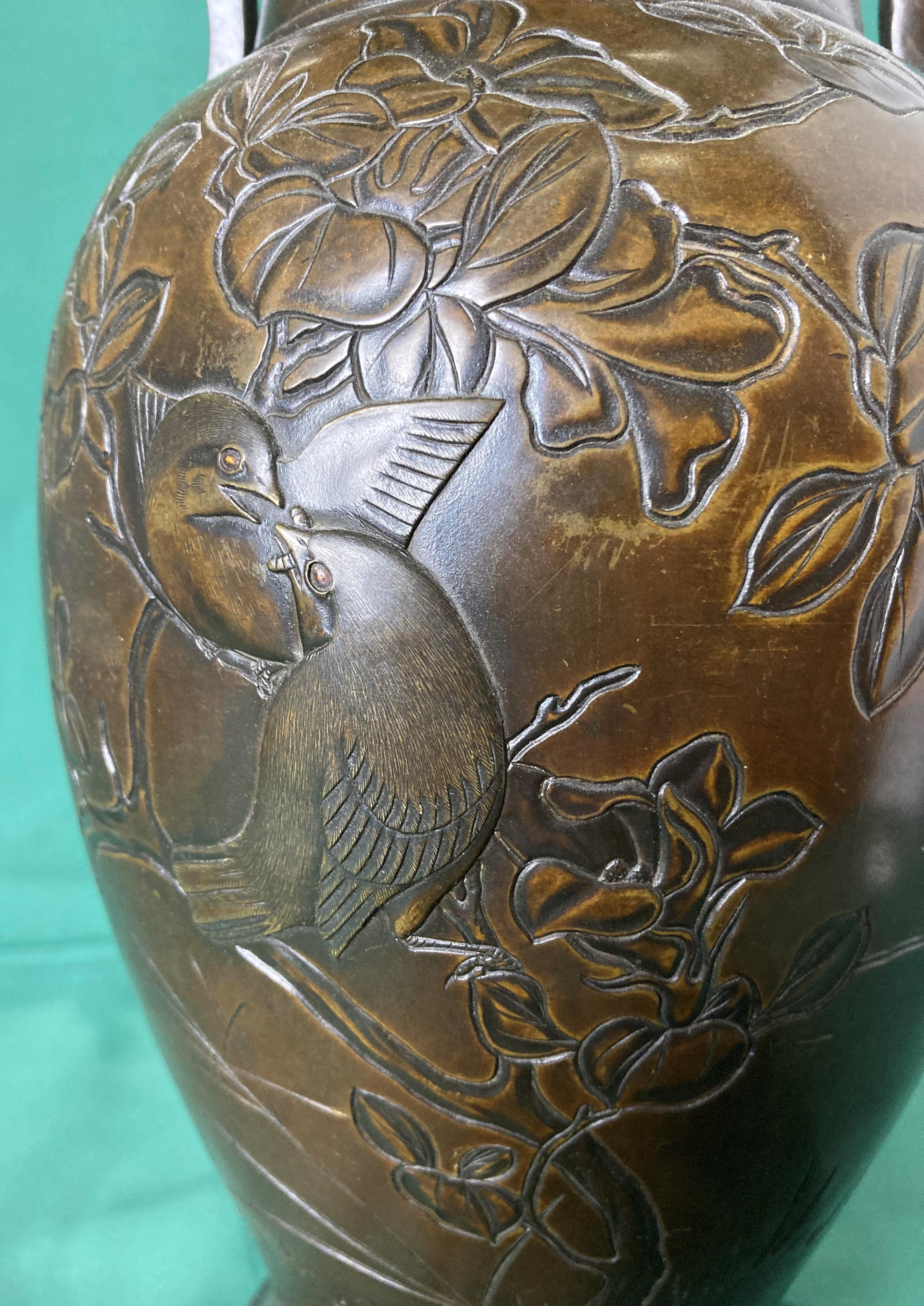 A bronze Oriental vase with engraved details of birds and floral designs and lugged handles, 34. - Image 3 of 4