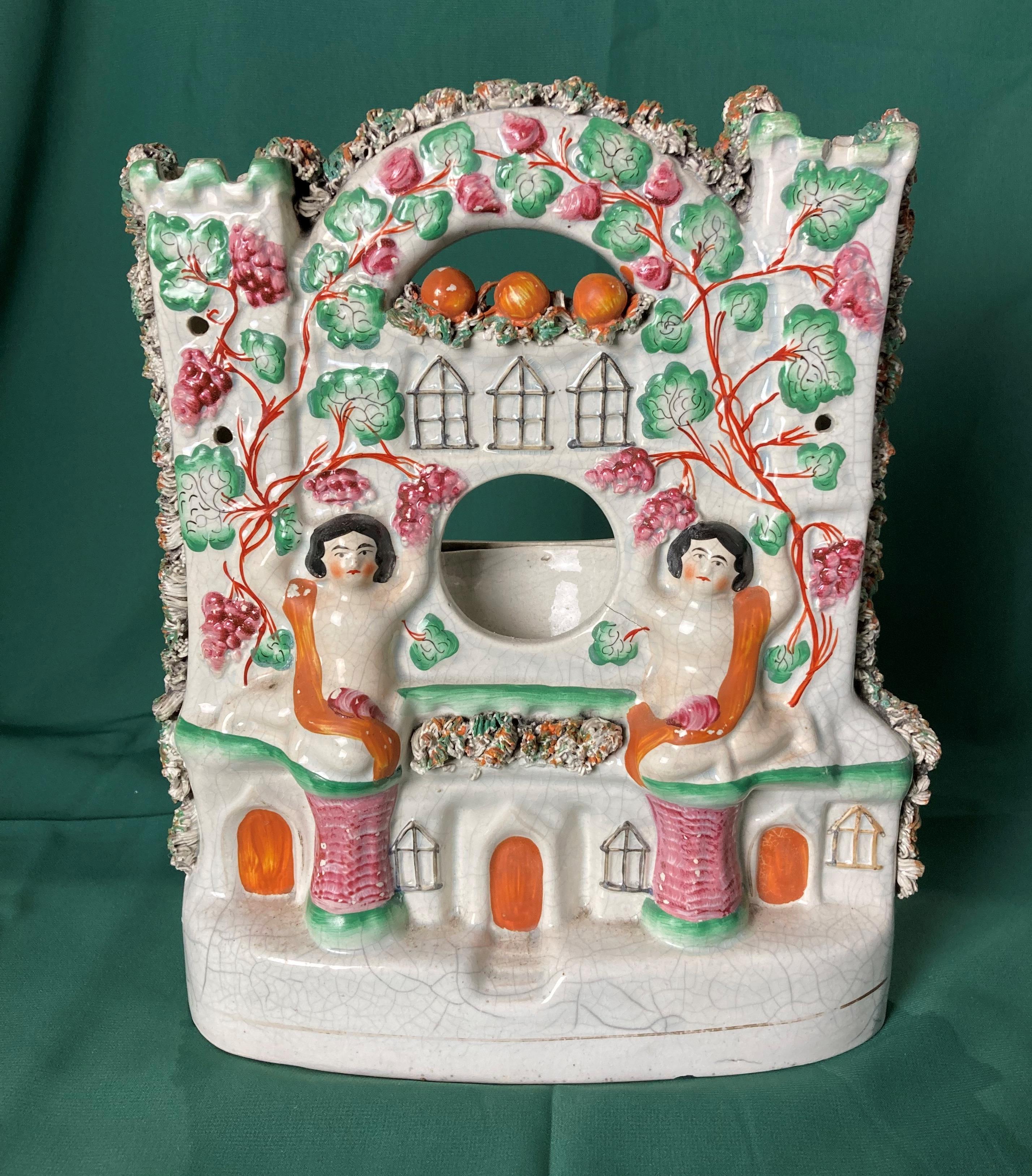 19th Century Staffordshire Pottery Castle flat-back pocket watch holder with two ladies/cherubs to