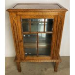 Arts & Crafts oak single-door display cabinet with hand-carved details,