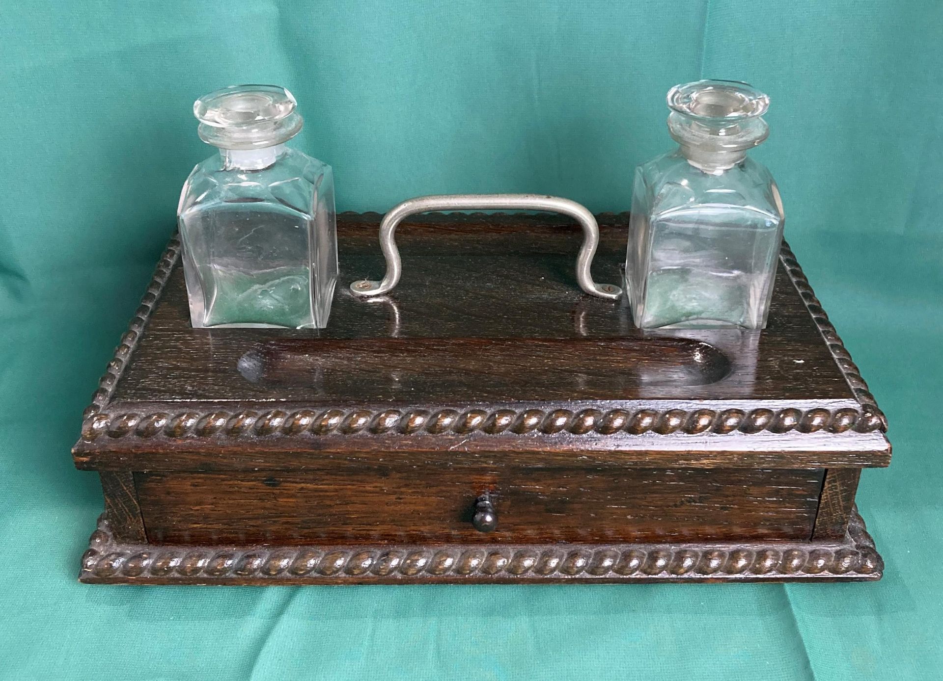 Mahogany double ink well stand with original glass bottles, both with stoppers and single drawer,