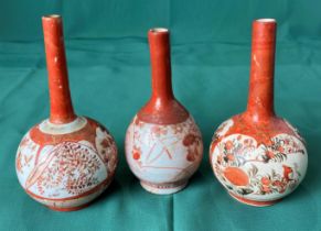 Three assorted Japanese Kutani small bud vases with long necks all decorated in floral design