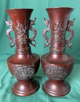 A pair of bronze vases with dragon handles and dragon and foliage design (26cm high),