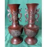 A pair of bronze vases with dragon handles and dragon and foliage design (26cm high),