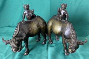 Pair of vintage Oriental bronze water buffalo with figure holding bird,