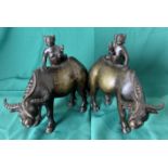 Pair of vintage Oriental bronze water buffalo with figure holding bird,