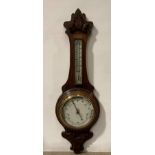 A vintage oak cased Aneroid barometer with white porcelain face and lift-off thermostat,