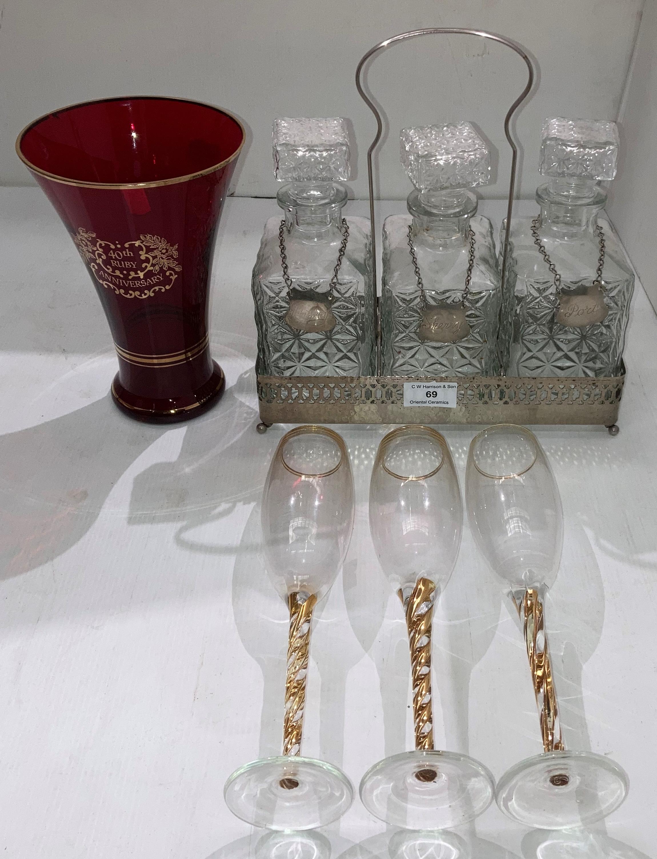 Set of three decanters in silver-coloured carry holder, each decanter with hanging tag (whisky,