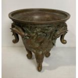 An Oriental bronze incense burner with elephant head legs and two elephant head handles with