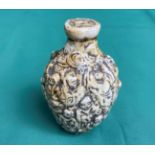 An antique hand-carved stone snuff/scent bottle decorated with Buddha and monks,