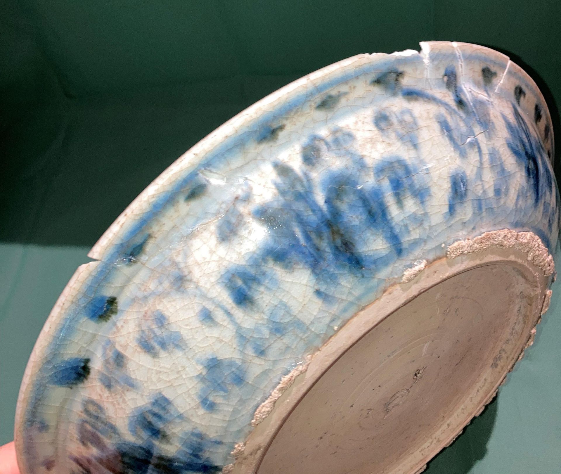 An antique Oriental blue and white glazed bowl with fish in pond to centre (bowl damaged and been - Image 4 of 6