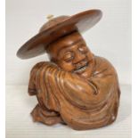 An Oriental wooden hand-carved figurine of sleeping man with engraved hat,