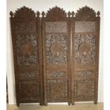 An Asian wooden hand-carved three-panel display screen with detailed peacock to each panel and