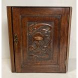 An oak Arts & Crafts corner cupboard,