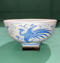 An antique blue and white Oriental porcelain bowl with three golden pheasants and symbol to base in