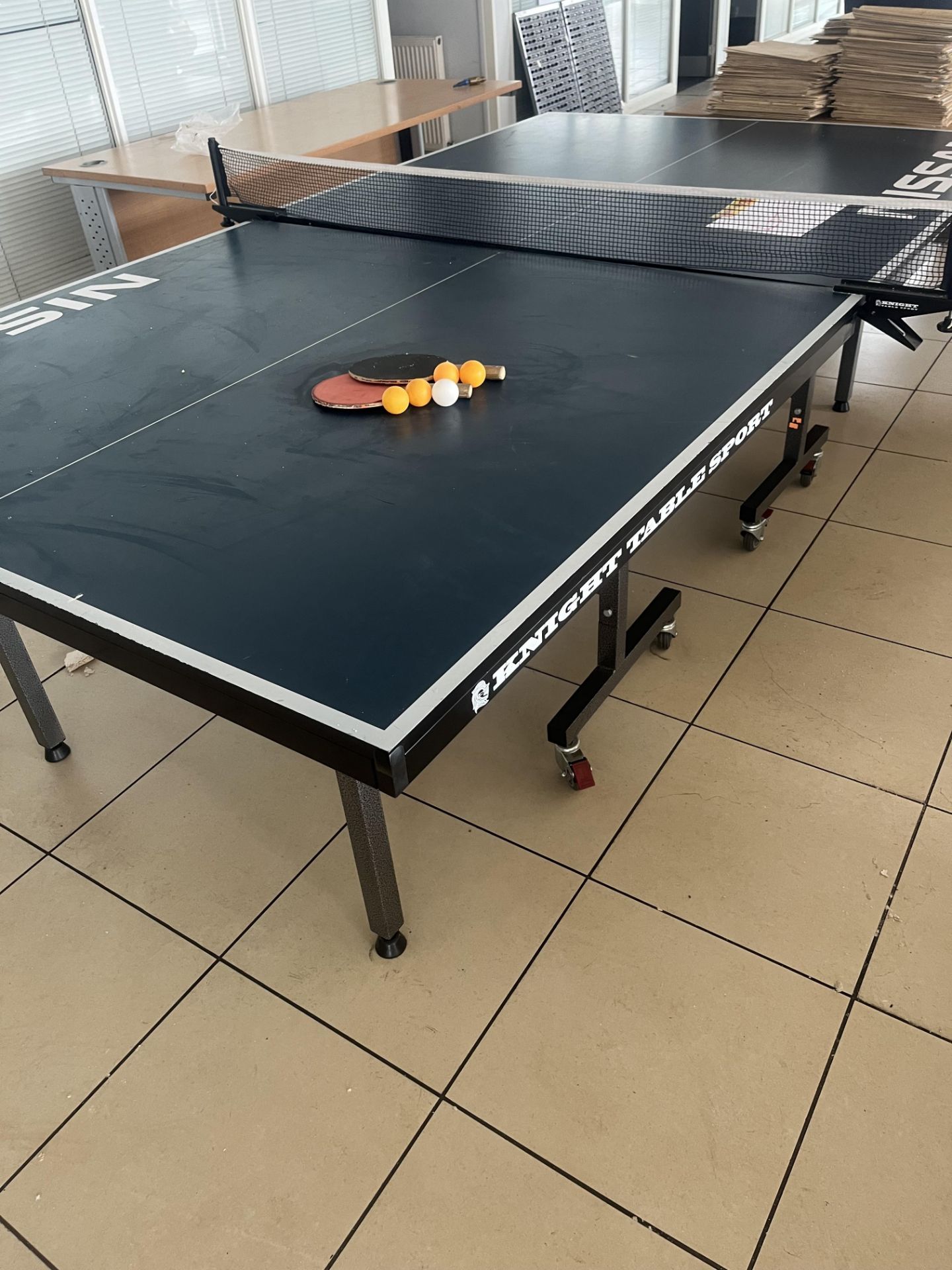 Nissan fold away table tennis table complete with two bats and four balls