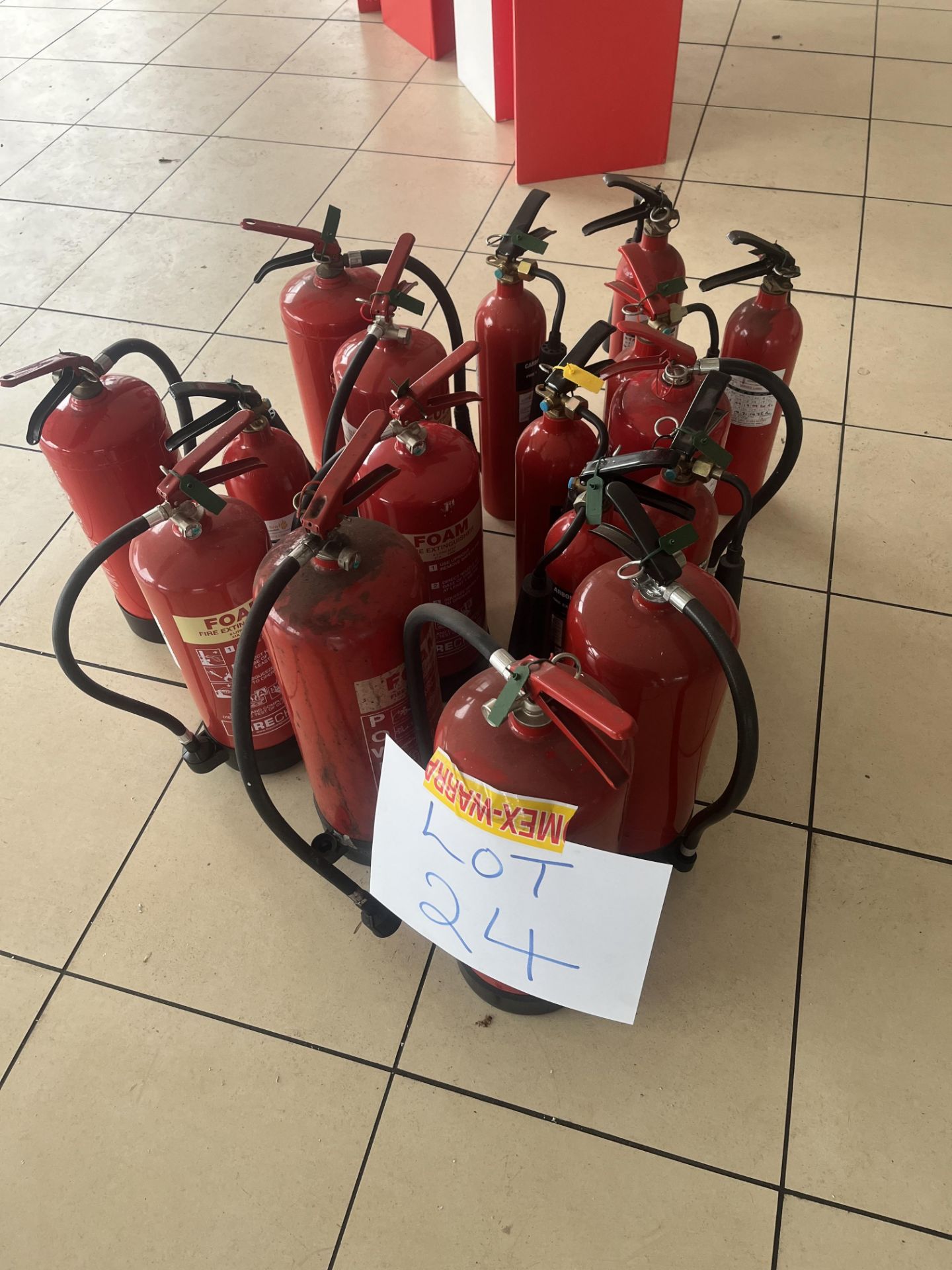 Sixteen assorted fire extinguishers including foam, CO2 and water,