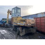 Liebherr 912 Litronic Wheeled and adapted scrap yard material handler with extended reach.