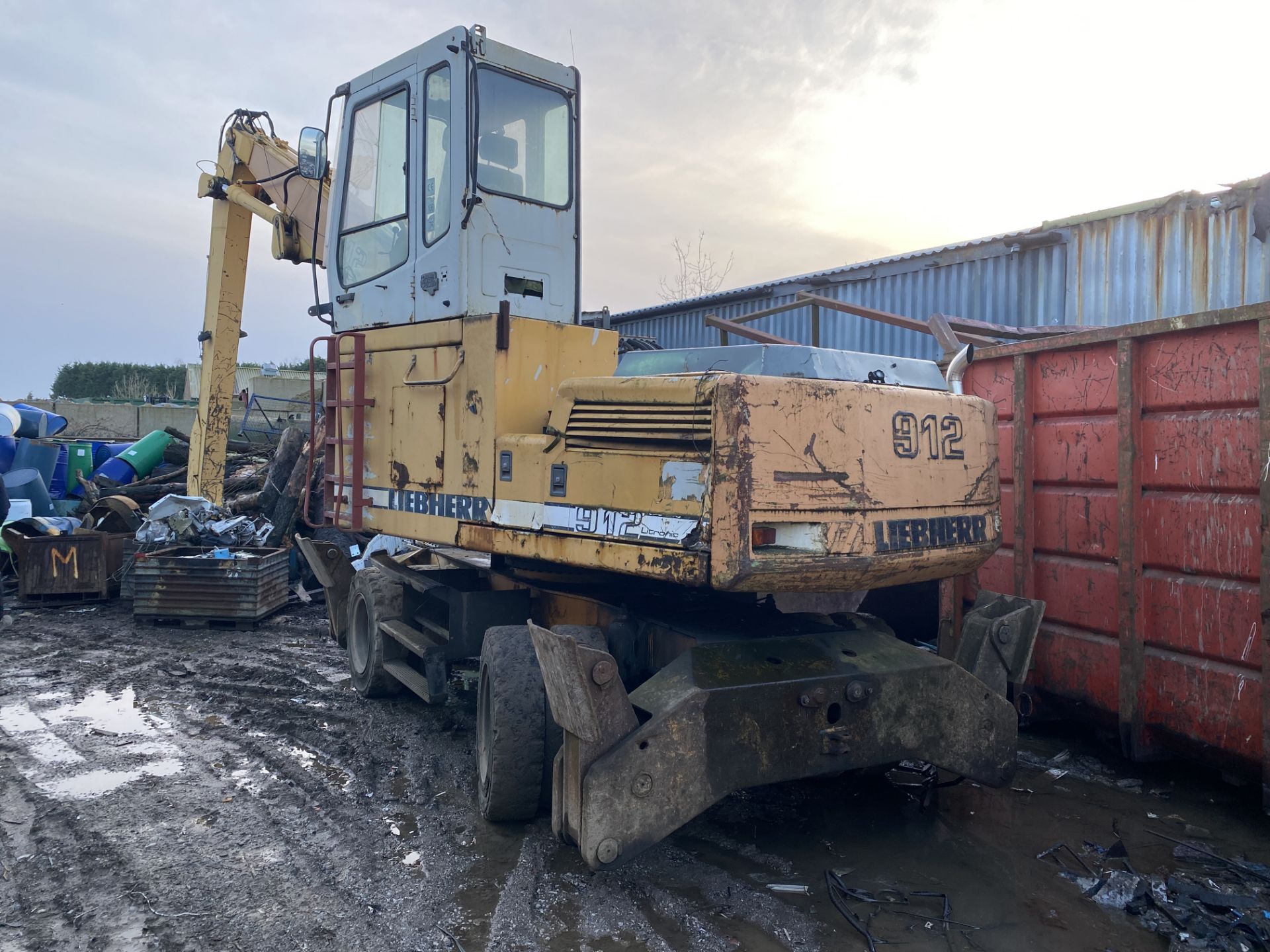 Liebherr 912 Litronic Wheeled and adapted scrap yard material handler with extended reach.