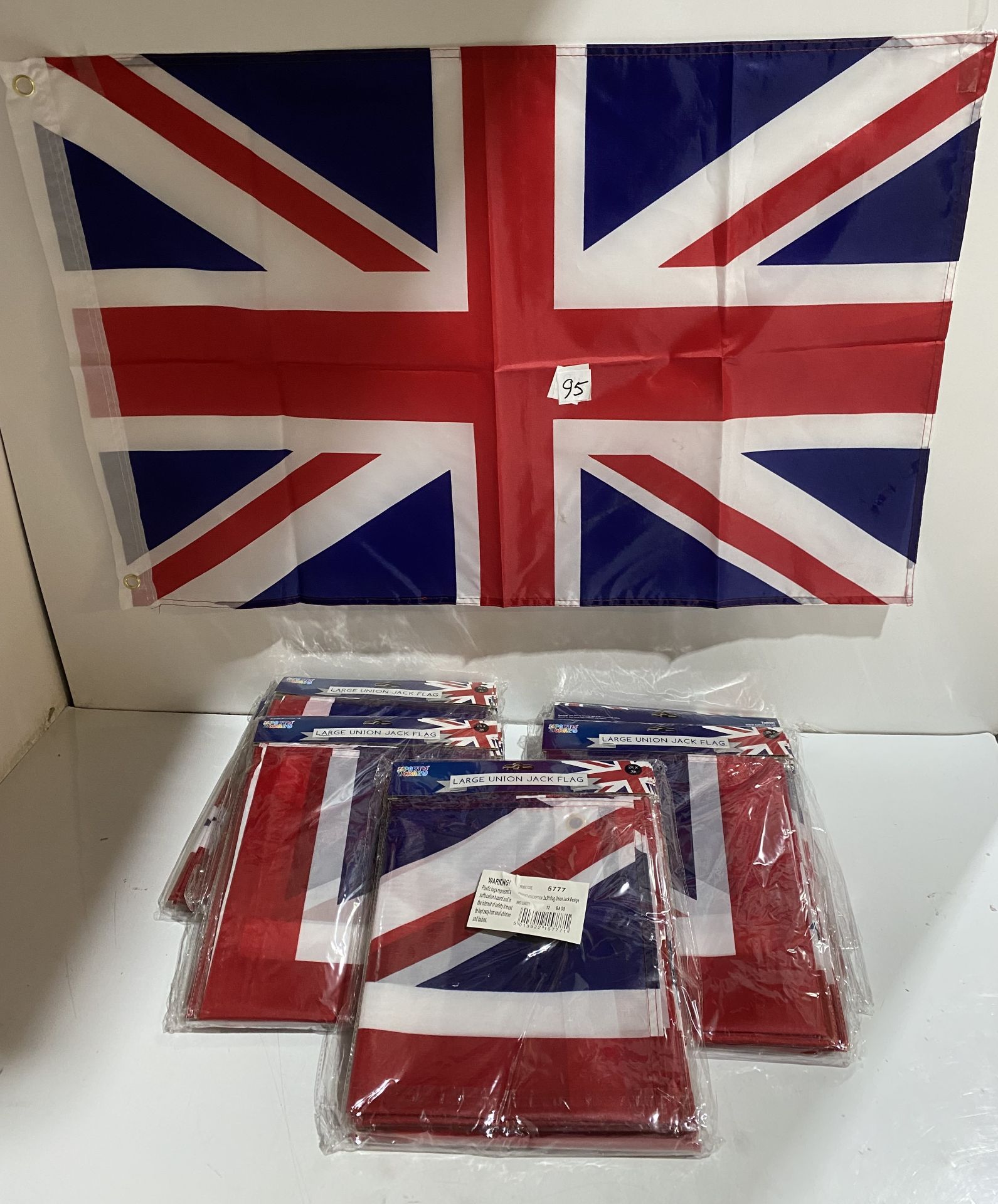 7 x packs of 12 large union jack flags with 2 brass eyelets (saleroom location: G12)