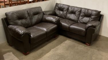 A brown leather-finish two-piece suite including a three-seater and two-seater settee (saleroom