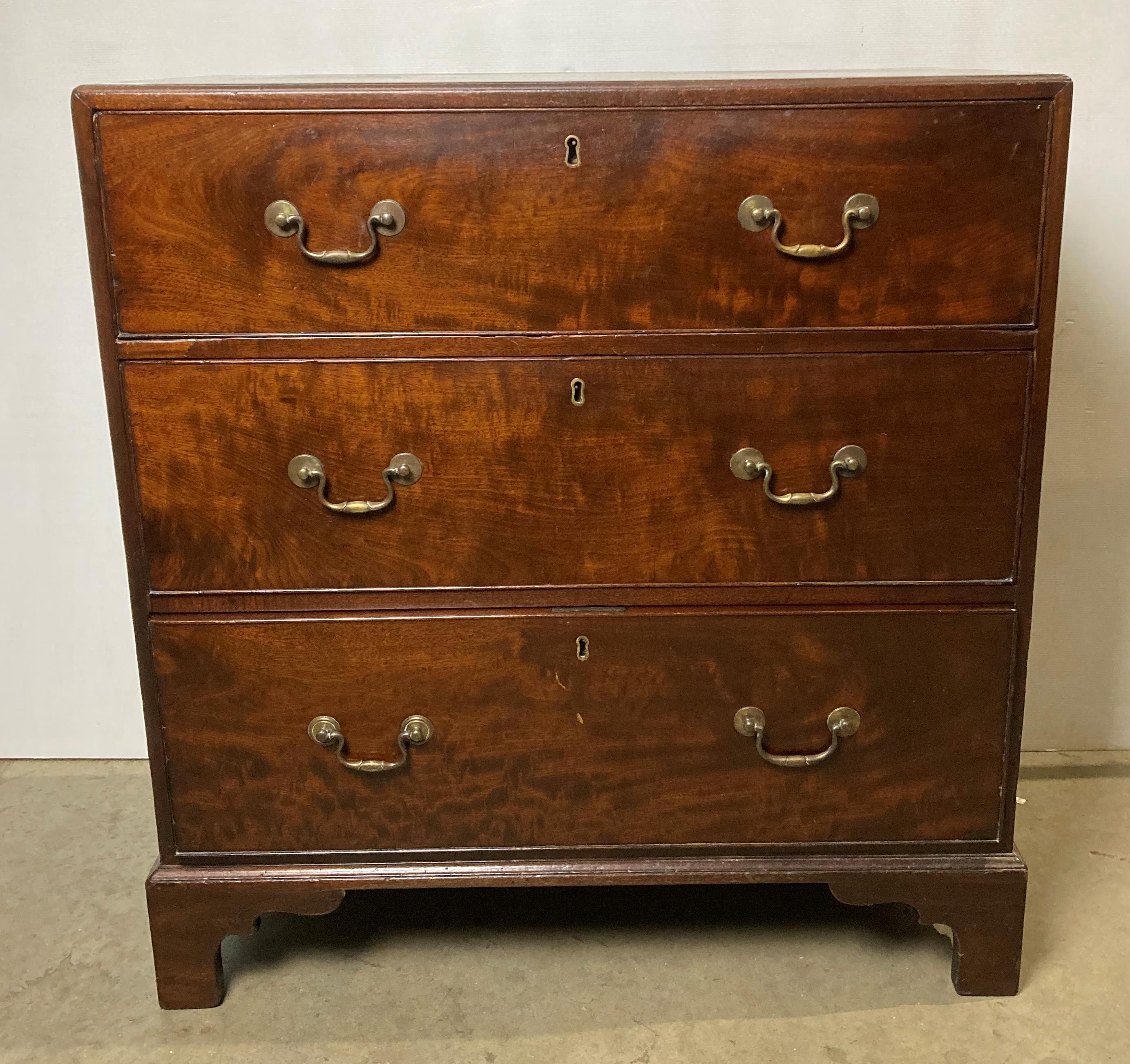 A mahogany Georgian-style three-drawer chest of drawers with metal drop handles,