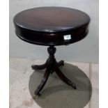 Mahogany finish drum side table with four drawers,