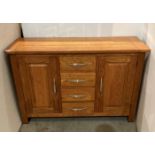 A solid oak small sideboard with two doors and four central drawers, 120.5 x 40 x 80.