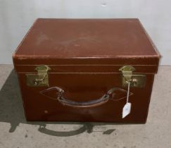 A brown leather box luggage case with brass-finish clasps,