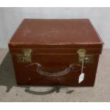 A brown leather box luggage case with brass-finish clasps,