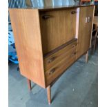 A teak three-door, two-drawer wall unit,