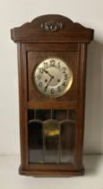 Mahogany cased wall-clock with key and pendulum with cut glass panels,