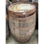 An aged oak whisky/sherry barrel with metal banding,