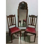 A mahogany cheval mirror (157cm high) and a pair of oak dining chairs with red leather-finish seats