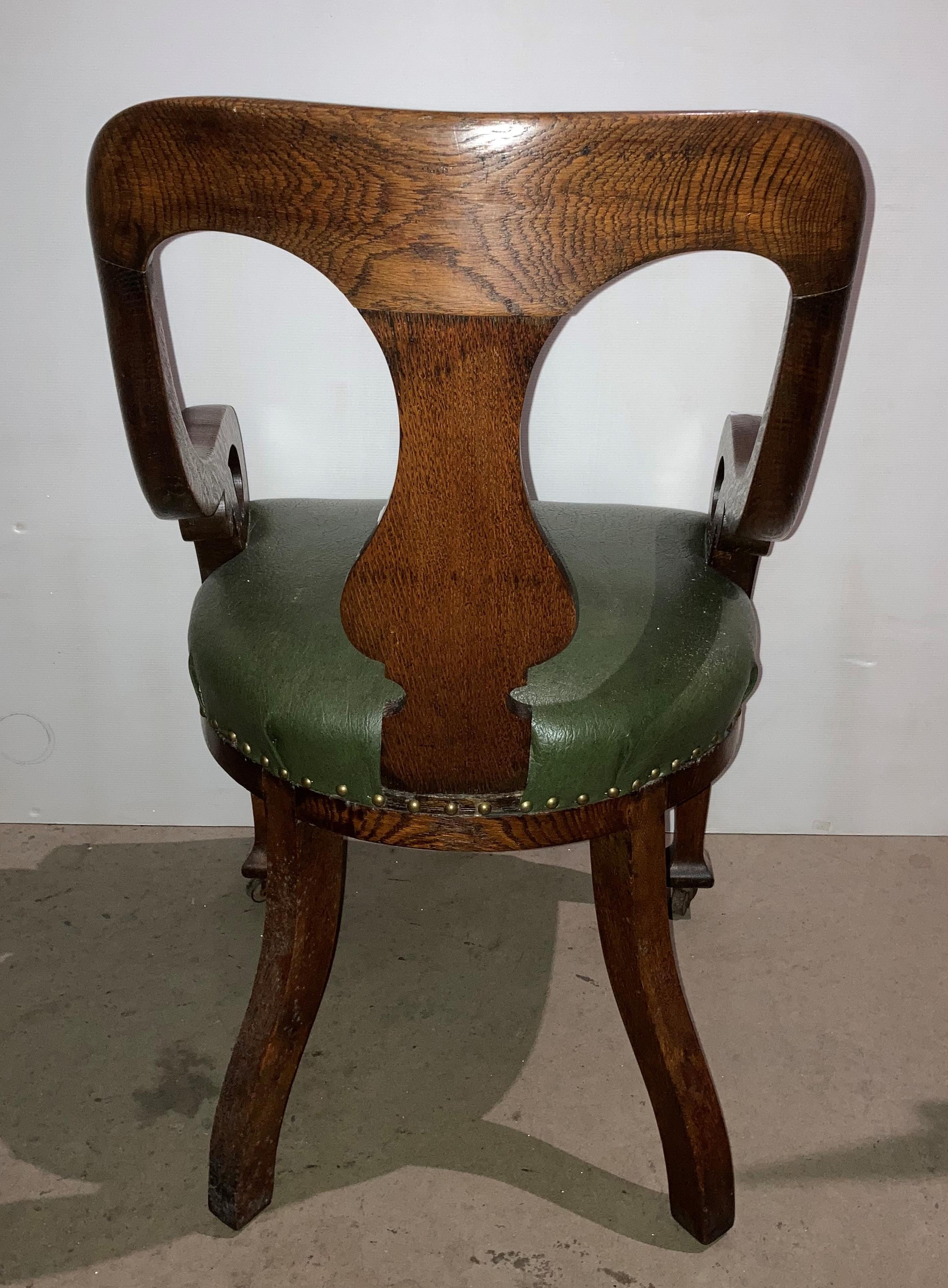 An oak armchair with green leather-finish seat and open scroll arms (saleroom location: S2 QA02) - Image 3 of 4