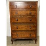 An oak five-drawer chest of drawers with printing block handles on cabriole legs,