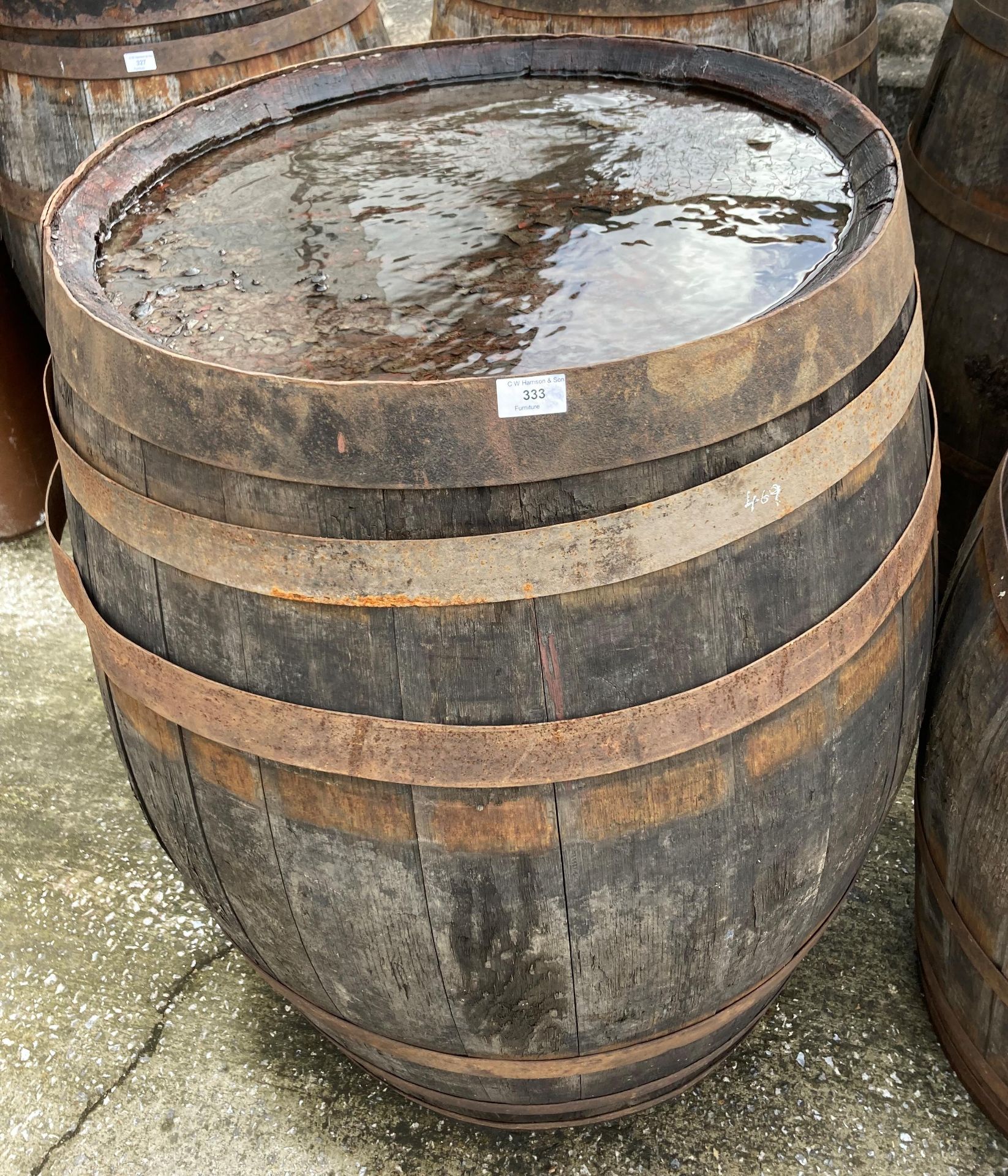 An aged oak whisky/sherry barrel with metal banding,