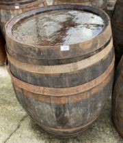 An aged oak whisky/sherry barrel with metal banding,