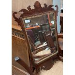 An ornate walnut framed wall mirror,