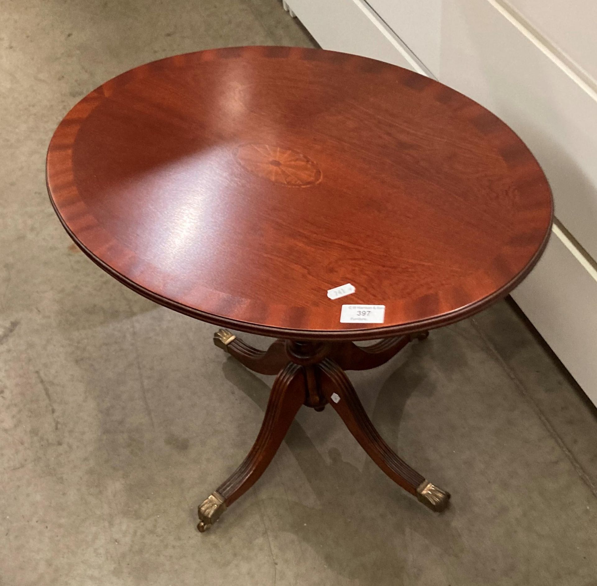 A small oval side table with shell inlay to centre,