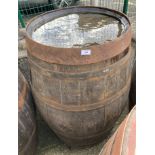 An aged oak whisky/sherry barrel with metal banding,