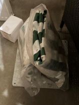 A metal parasol stand and two packaged green and white striped covers (3) (saleroom location: